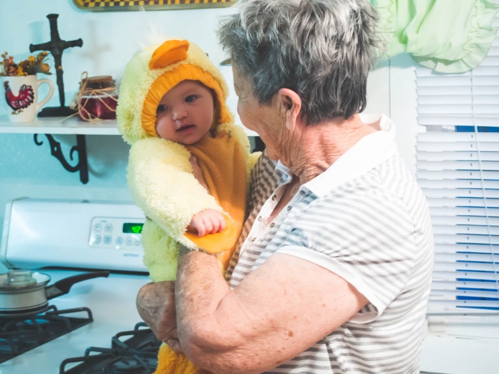 elderly woman holding child